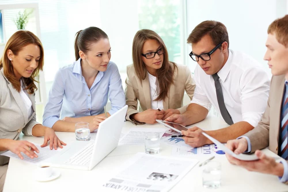 Colleagues making a decision around a workstation